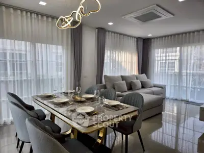 Modern living room with elegant dining area and stylish lighting