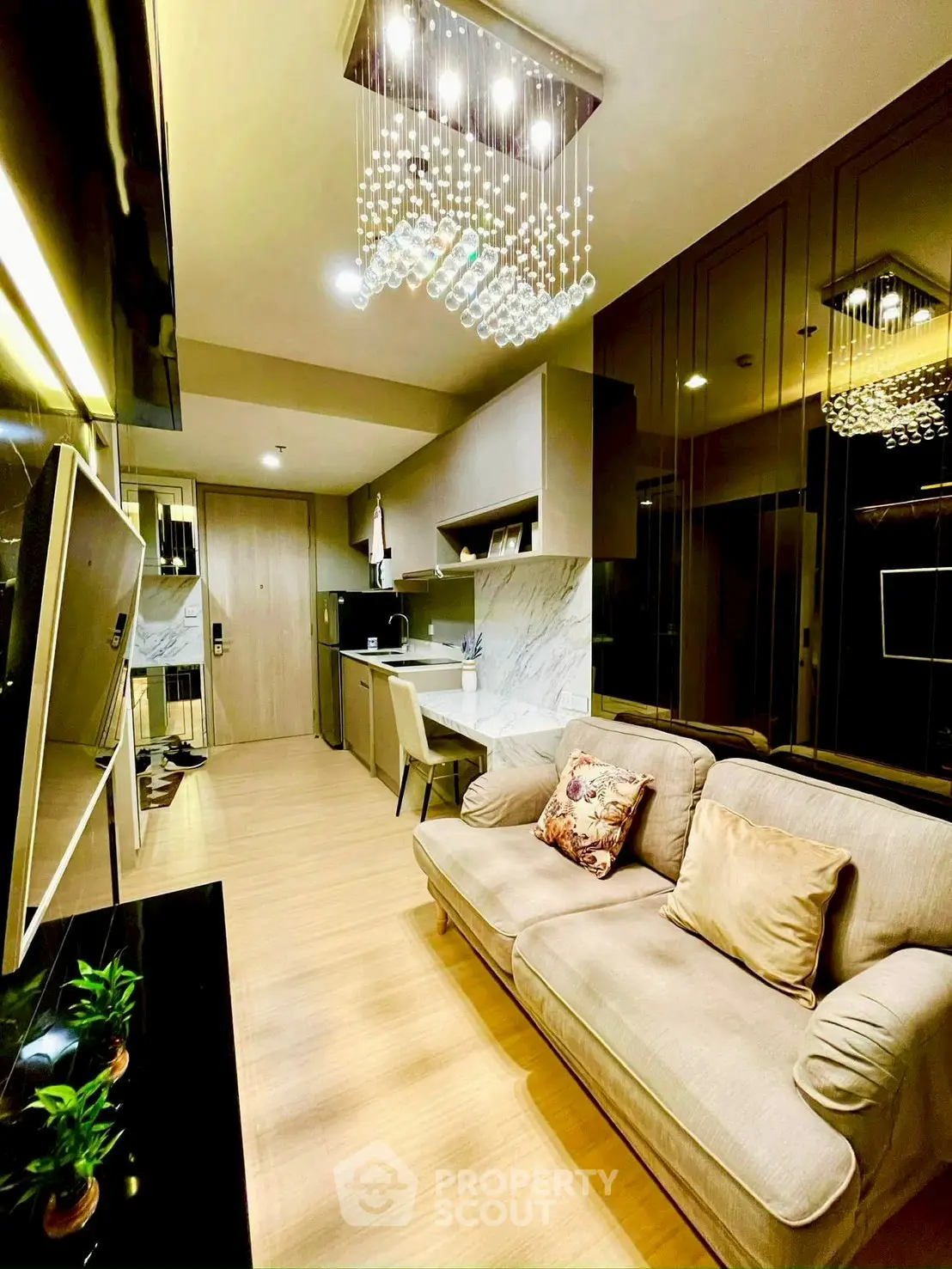 Modern living room with elegant lighting and cozy seating in a stylish apartment.