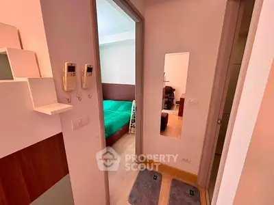 Modern apartment hallway with view into a cozy bedroom featuring stylish decor and wooden flooring.