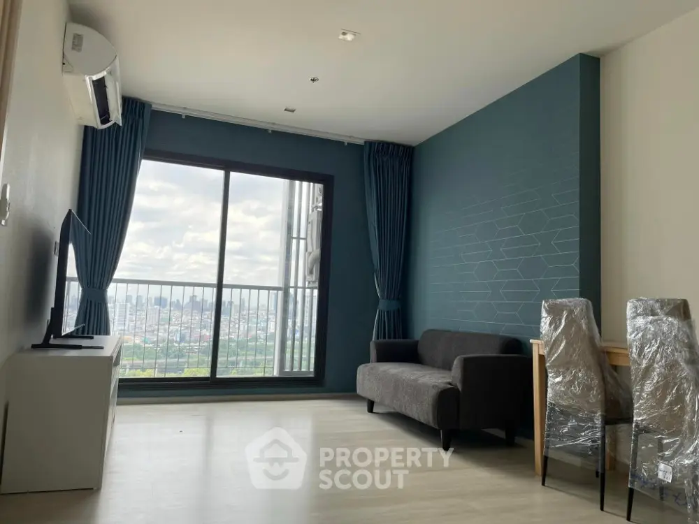 Modern living room with panoramic city view and stylish furnishings.