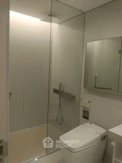 Modern bathroom with sleek shower and contemporary fixtures.