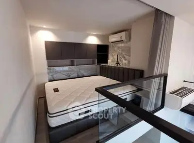 Modern bedroom with stylish decor and air conditioning in a contemporary apartment.