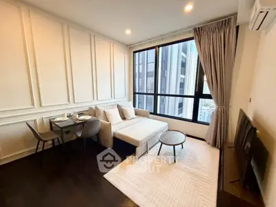 Modern living room with elegant decor and city view, featuring cozy seating and dining area.