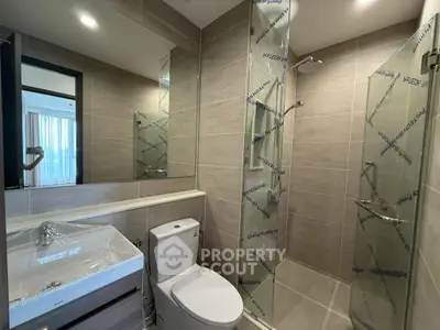 Modern bathroom with sleek shower and stylish fixtures in a contemporary apartment.