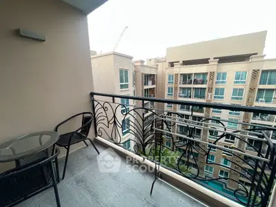 Charming balcony with stylish railing and city view in modern apartment complex.