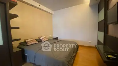 Spacious bedroom with modern decor and cozy ambiance