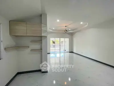 Spacious modern living room with sleek design and large windows for natural light.