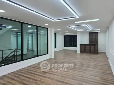 Spacious modern living room with elegant lighting and wooden flooring
