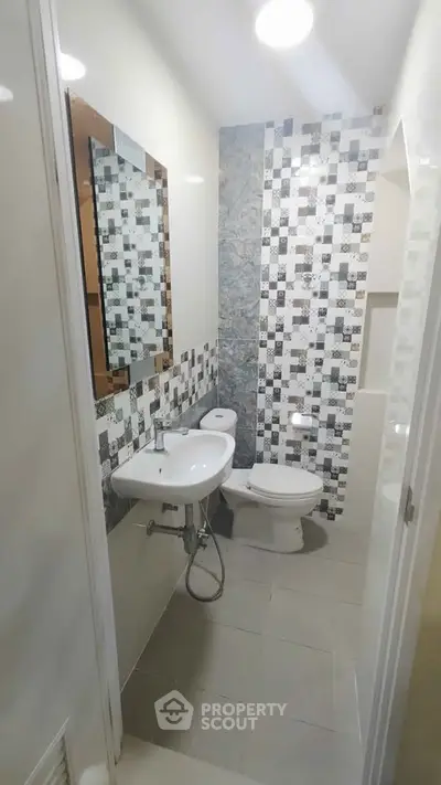 Modern bathroom with stylish tile design and compact layout