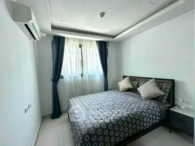 Modern bedroom with stylish decor and natural light in a contemporary apartment.