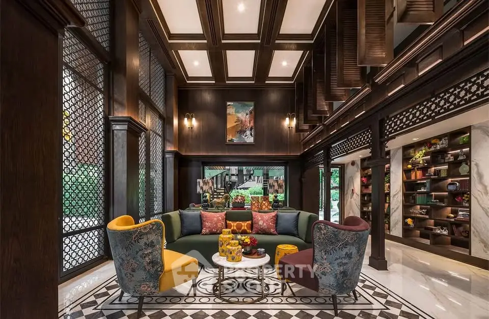 Luxurious living room with high ceilings, elegant decor, and vibrant seating in a sophisticated setting.