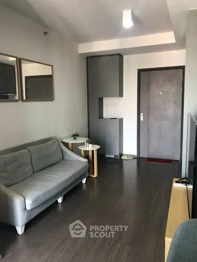 Modern living room with sleek grey sofa and minimalist decor