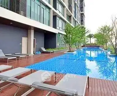 Luxurious apartment complex with stunning outdoor pool and modern amenities.