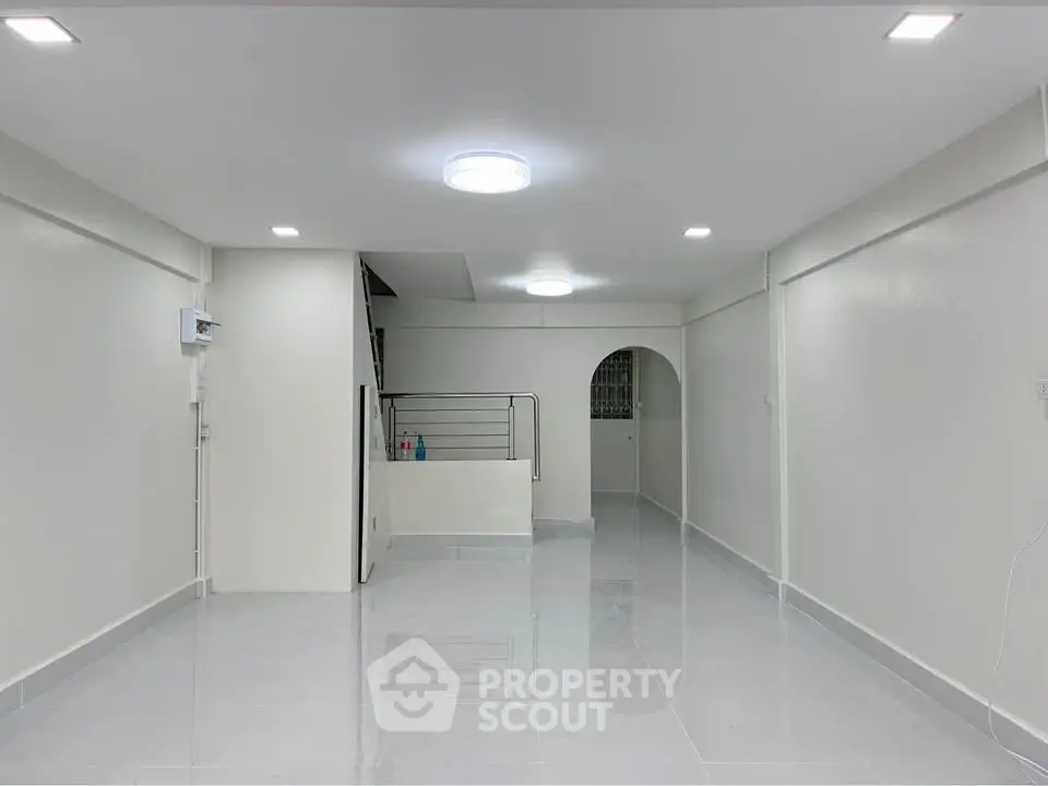 Spacious and modern interior with sleek lighting and glossy flooring, perfect for versatile living arrangements.