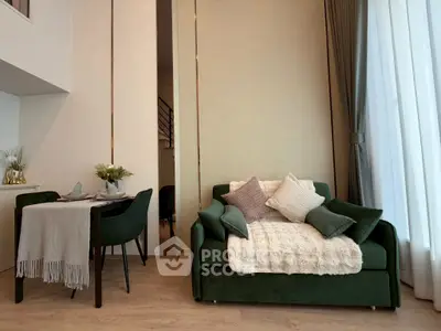 Chic modern living room with elegant dining area and plush green sofa