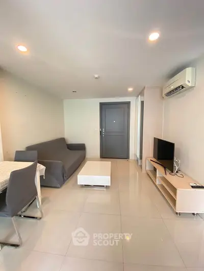 Modern living room with sleek furniture and air conditioning in a stylish apartment.
