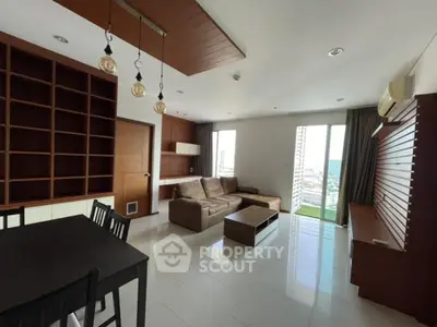 Spacious modern living room with city view, featuring elegant furniture and ample natural light.
