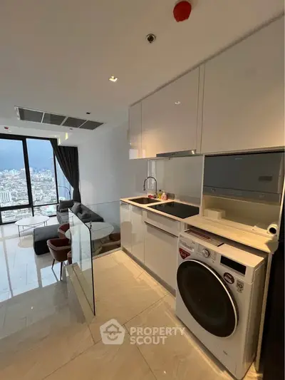 Modern open-layout kitchen with city view, featuring sleek appliances and stylish living area.