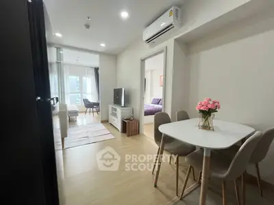 Modern apartment interior with open living and dining area, featuring stylish decor and natural light.