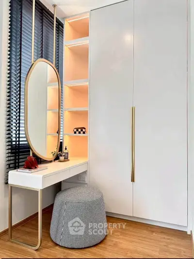 Stylish modern bedroom corner with sleek wardrobe and elegant vanity setup.