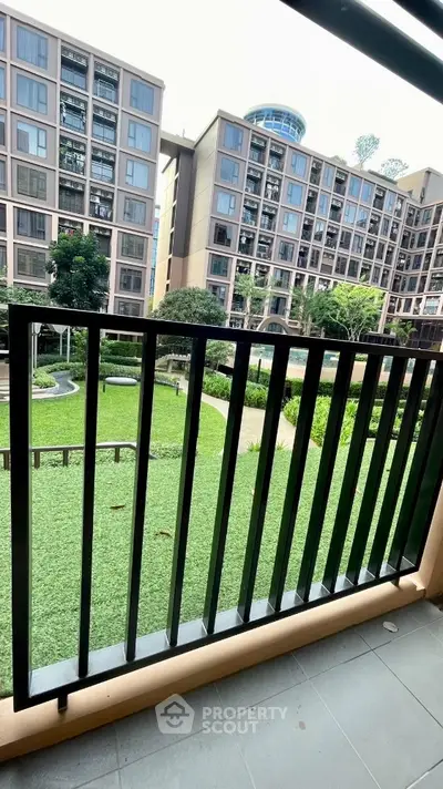 Modern apartment balcony with garden view in urban residential complex