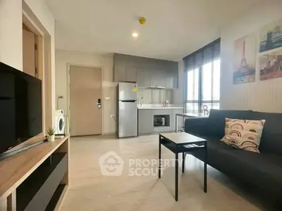Modern open-plan living room with sleek kitchen and cozy seating area, perfect for urban living.
