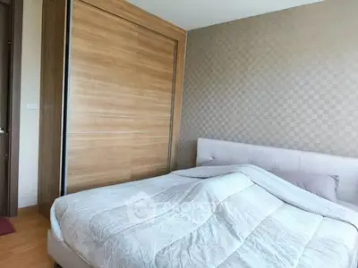 Cozy bedroom with modern wooden wardrobe and elegant wallpaper design.