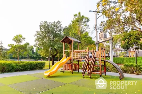 Charming community playground nestled in a lush green park, perfect for family-friendly outdoor activities and relaxation.