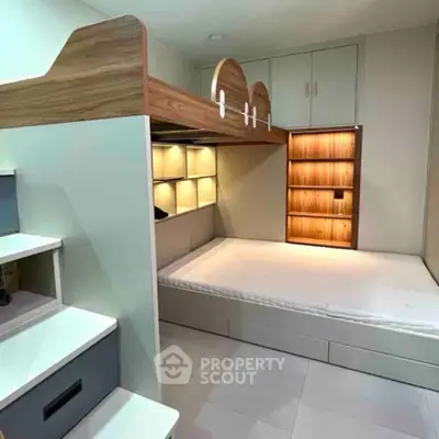 Modern bedroom with loft bed and built-in storage solutions