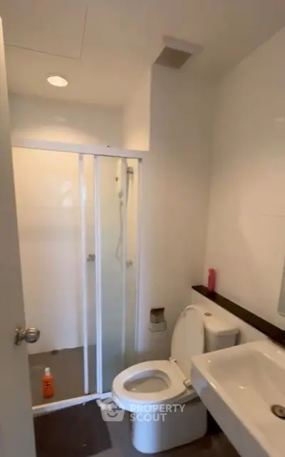 Modern bathroom with shower and sleek fixtures in a contemporary home.