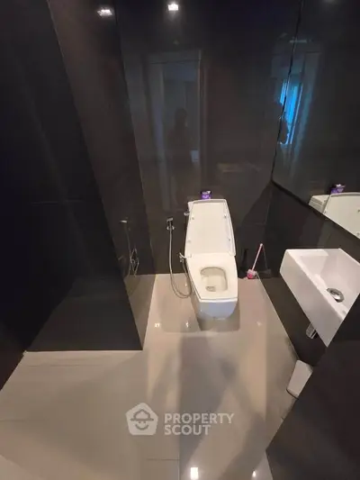 Modern bathroom with sleek black tiles and contemporary fixtures