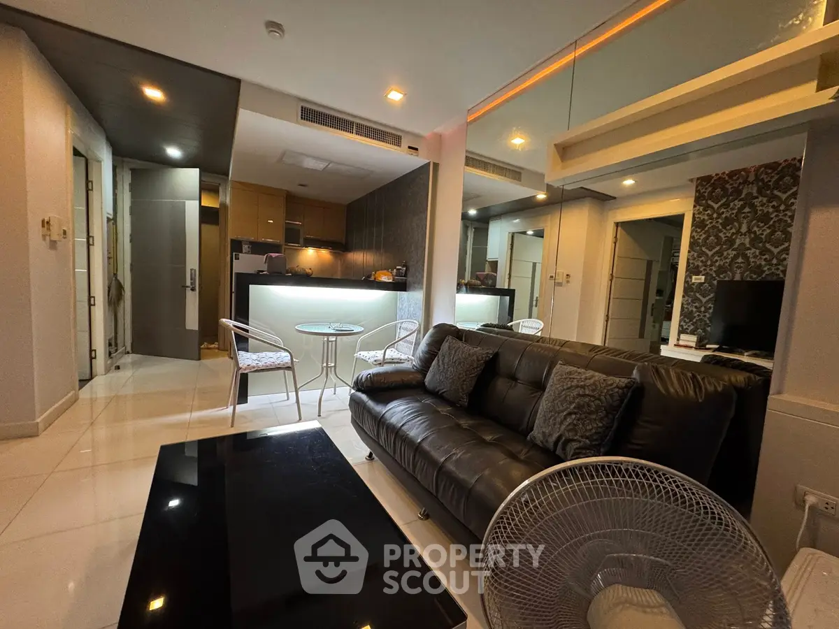 Modern living room with sleek furniture and open kitchen layout