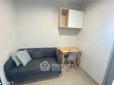 Cozy study nook with modern sofa and desk in compact apartment