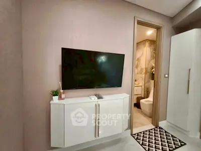 Modern living space with wall-mounted TV and elegant bathroom view