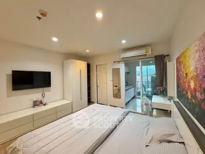 Modern bedroom with stylish decor and balcony access in a contemporary apartment.