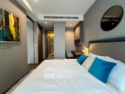 Luxurious bedroom with modern decor and plush bedding in upscale apartment