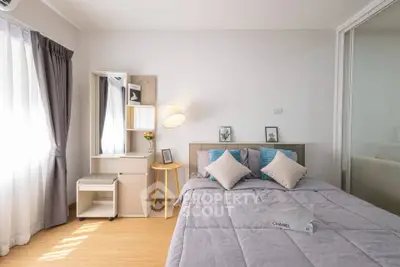 Bright and cozy bedroom with modern decor and ample natural light.