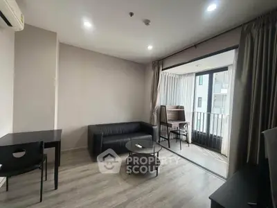 Modern living room with sleek furniture and balcony access in urban apartment