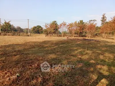 Expansive plot of land with clear skies and lush greenery, perfect for development opportunities.