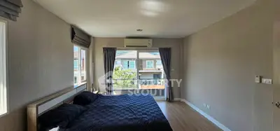 Spacious bedroom with large window and modern decor in a stylish home