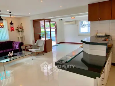Spacious living room with modern decor and open layout, featuring elegant furniture and ample natural light.