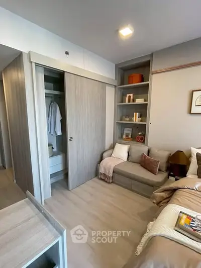 Modern bedroom with built-in closet and cozy seating area, perfect for relaxation and storage.