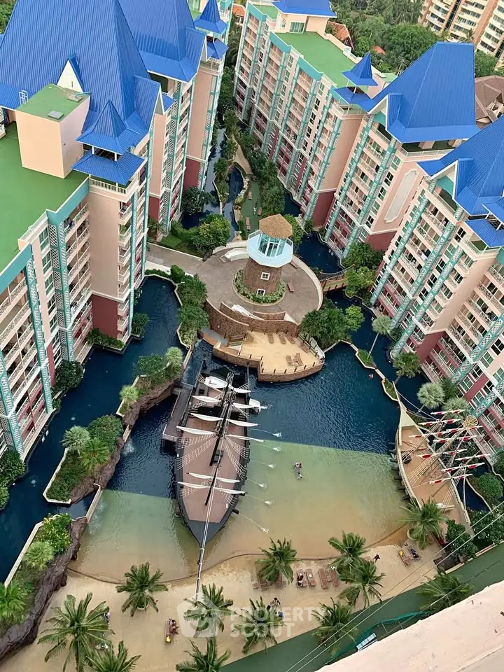 Stunning aerial view of a unique residential complex with a ship-themed pool and lush landscaping.