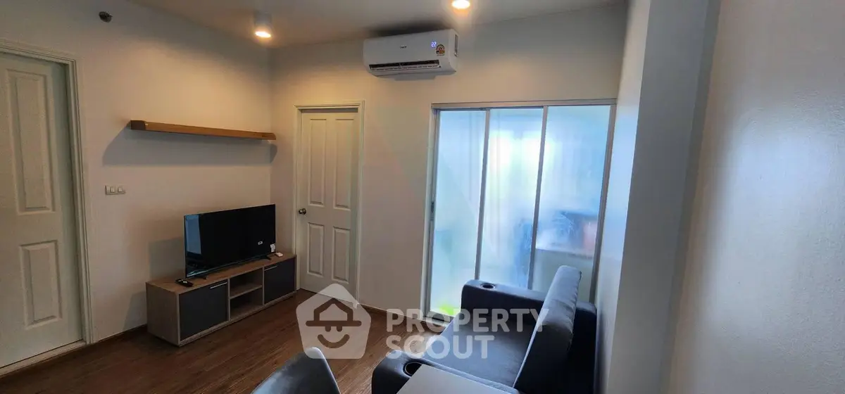 Modern living room with sleek furniture and air conditioning in a cozy apartment.