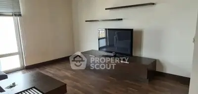 Modern living room with sleek TV stand and floating shelves, perfect for minimalist decor.