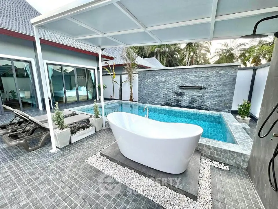 Luxurious outdoor pool area with freestanding bathtub and modern design