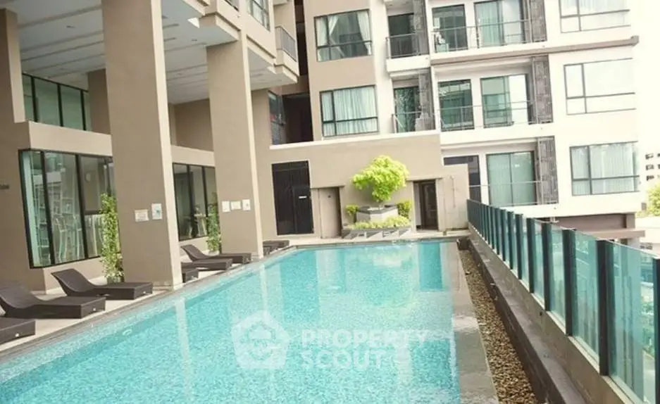 Luxurious apartment complex with modern pool and stylish architecture