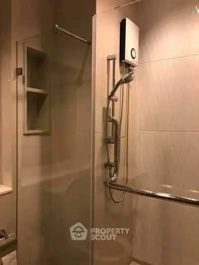 Modern bathroom with glass shower enclosure and sleek fixtures.