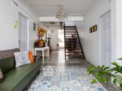 Charming interior with stylish tiled floor and staircase in a cozy living space.