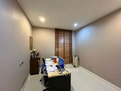 Modern study room with sleek desk and computer setup, ideal for productivity.